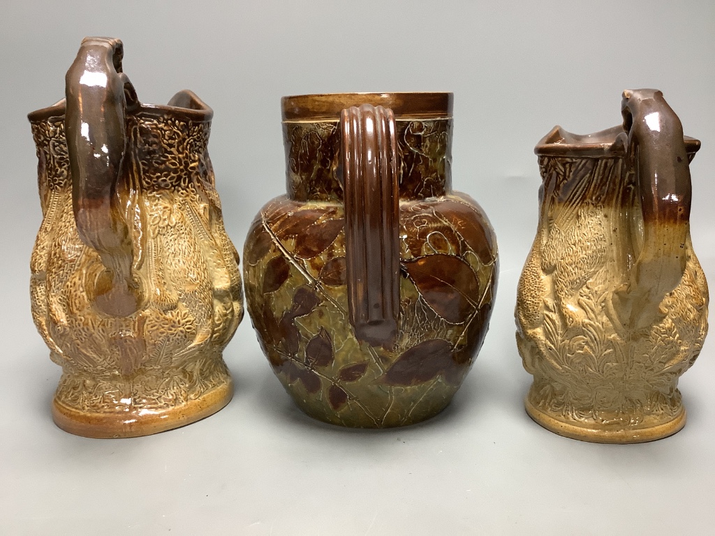 Two 19th century hunting related stoneware jugs and a Doulton Lambeth Autumn leaves stoneware jug, tallest 21cm